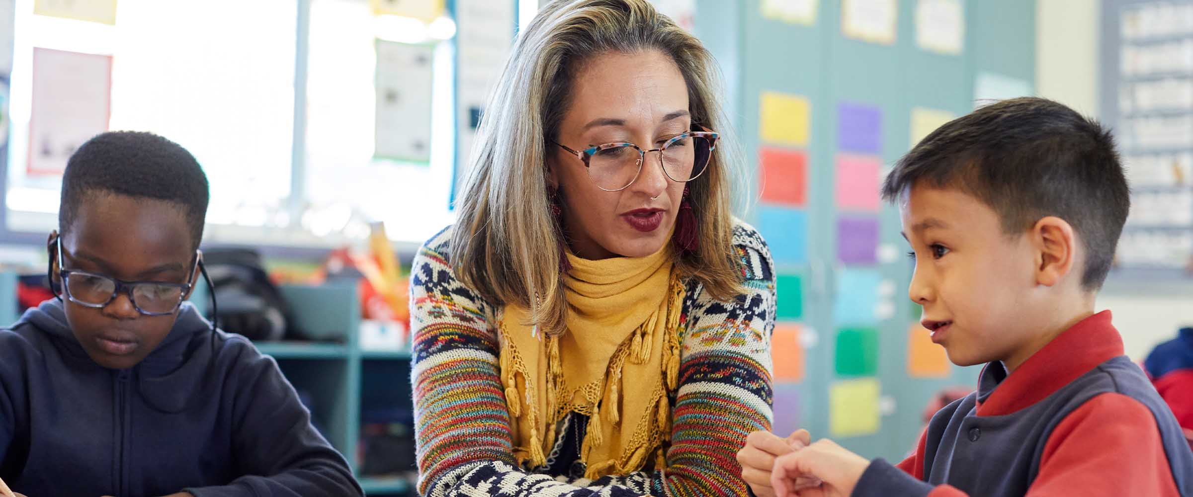 Teacher reviewing research papers that provide supporting evidence for Be You initiatives.