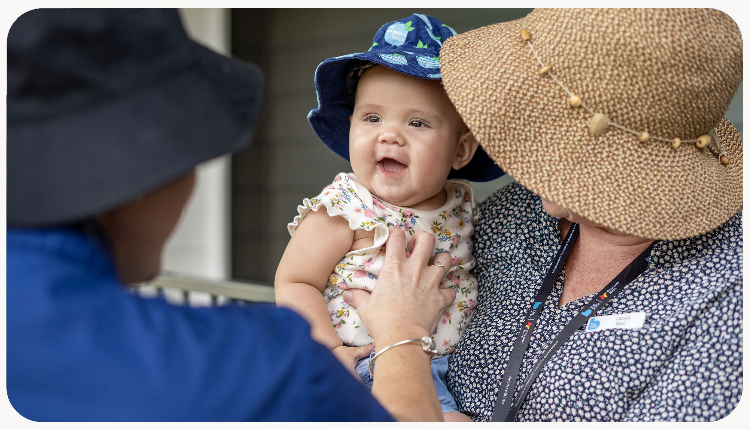 An educator holding a baby 