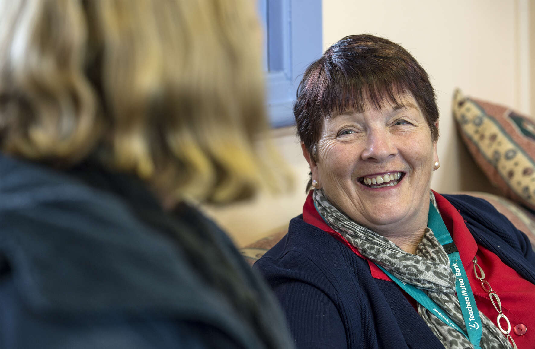 Two educators sit and talk together
