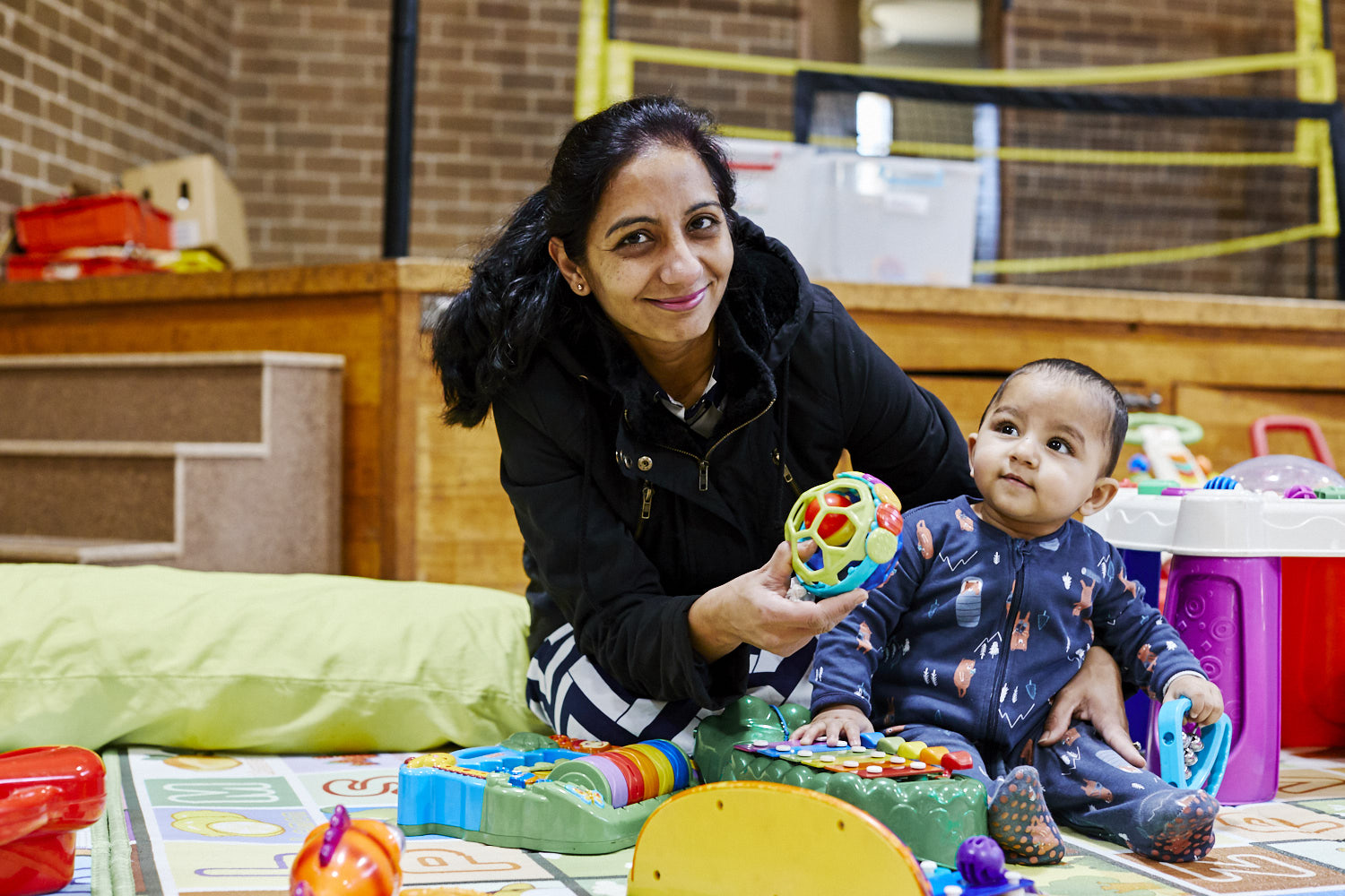 An educator playing with a baby 